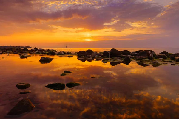 Pôr do sol sobre o mar, pedras em primeiro plano — Fotografia de Stock