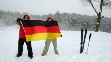 İki orta yaşlı adam Almanya bayrağı sallayarak hayranları spor