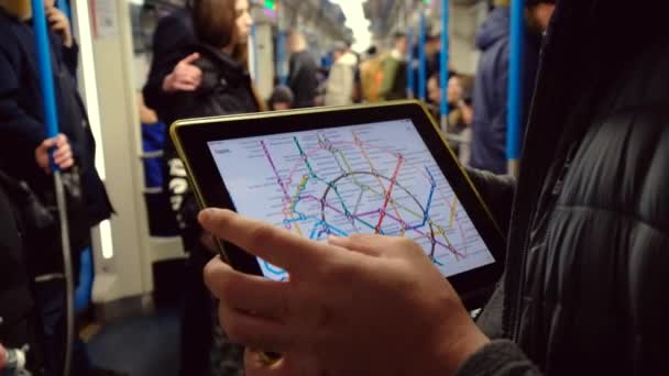 Man studeren een metrokaart op een tabletcomputer rijden op underground — Stockvideo