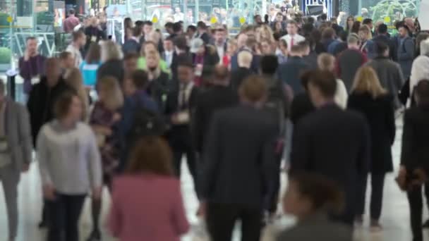 Crowd of people walking indoors, the foreground is defocused, — Stock Video