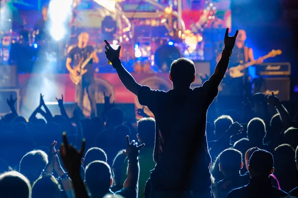 Fans at live rock music concert cheering