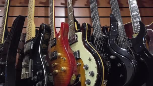 Guitars in store for sale — Stockvideo