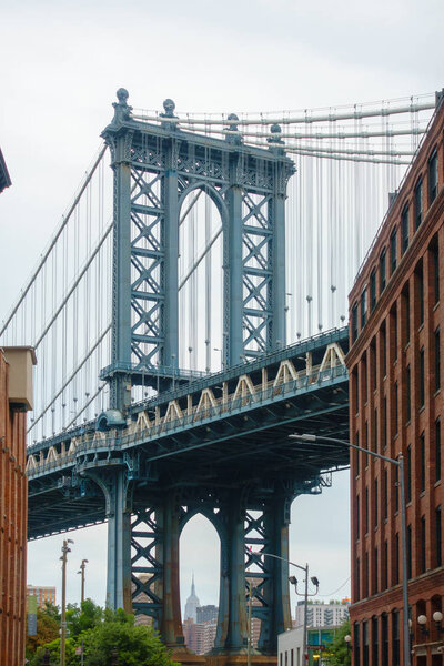 New York, USA - August 18, 2018: Pillar of Manhattan Bridge from alley in Dumbo district in Brooklyn