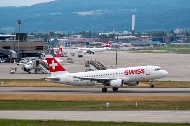 Swiss airlines airplanes preparing for take-off at day time in international airport