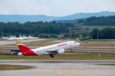 Iberia airlines airplanes taking-off at day time in international airport