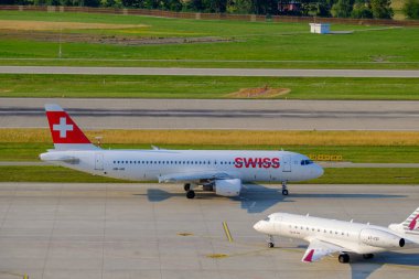 Swiss airlines airplanes preparing for take-off at day time in international airport