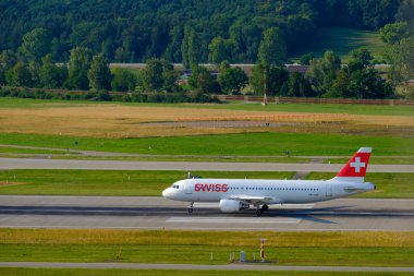 Swiss airlines airplanes preparing for take-off at day time in international airport