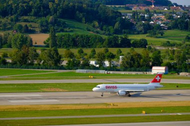 Swiss airlines airplanes preparing for take-off at day time in international airport