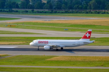 Swiss airlines airplanes preparing for take-off at day time in international airport