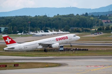 Swiss airlines airplanes preparing for take-off at day time in international airport