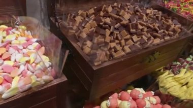 Chewing marmalade in a candy store