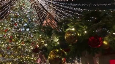 Tall christmas tree decorated and illuminated outdoors