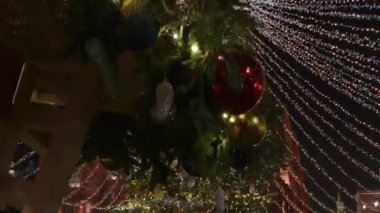 Tall christmas tree decorated and illuminated outdoors