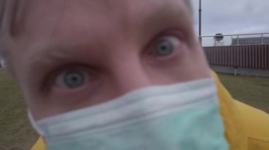 Man in medical masks moves to the camera