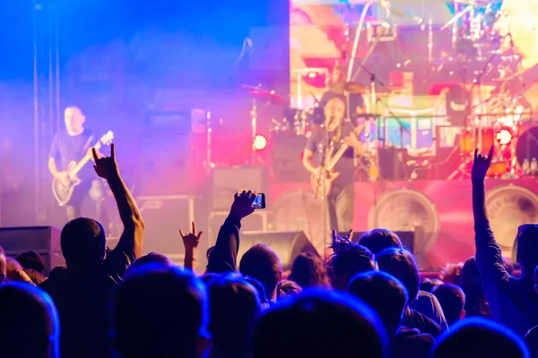 Fans luisteren naar rockband op het podium — Stockfoto
