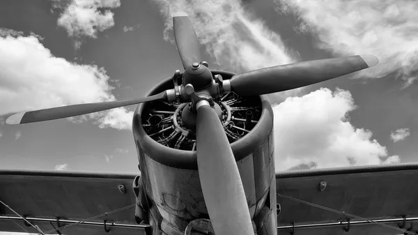 old aircraft with screws in black and white colors