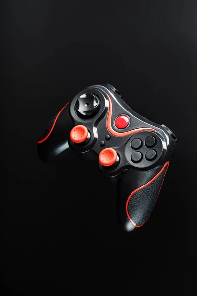 Game controller gamepad on black background. Device to control and control the game.