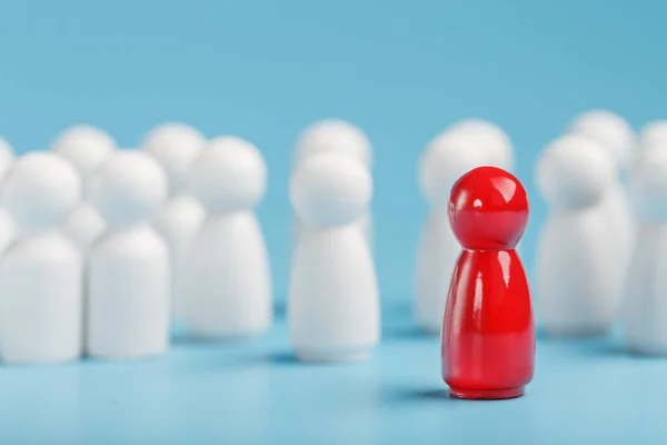 The leader in red leads a group of white employees to victory, HR, Staff recruitment. The concept of leadership.