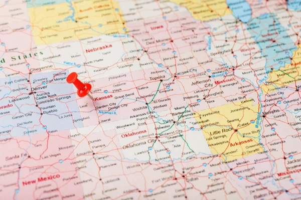 Red clerical needle on a map of USA, Kansas and the capital Topeka. Close up map of Kansas with red tack, United States map pin USA