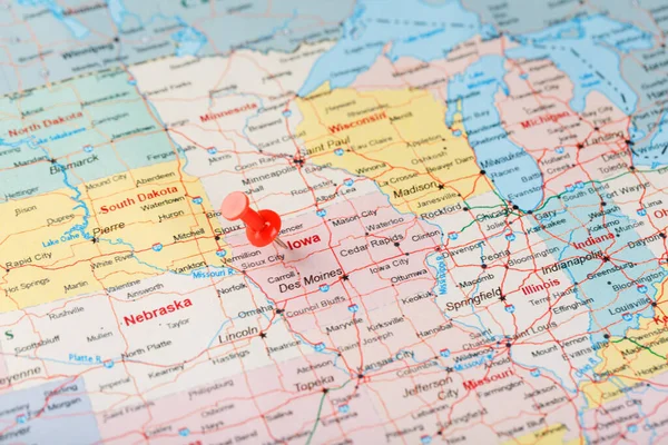 Red clerical needle on a map of USA, Iowa and the capital Des Moines. Close up map of Iowa with red tack, United States map pin USA