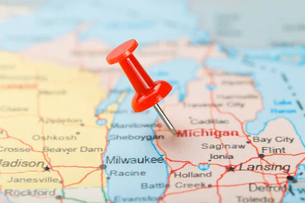 Red clerical needle on a map of USA, Michigan and the capital Lansing. Close up map of Michigan with red tack, United States map pin USA