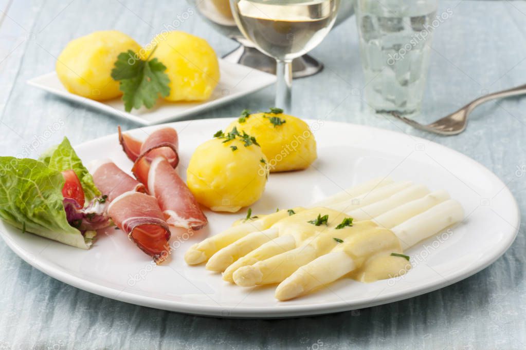 white asparagus with ham on a plate 