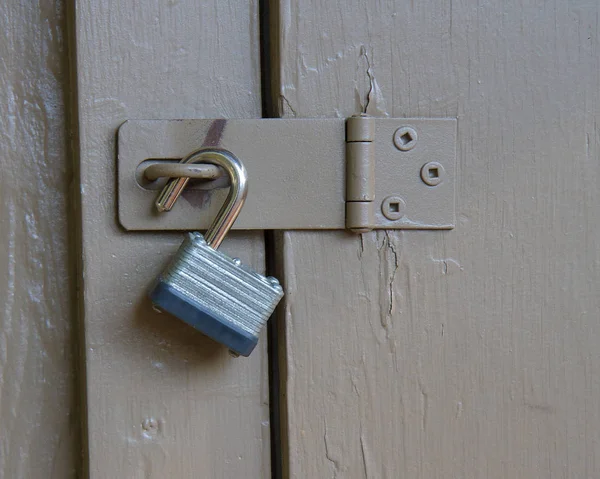 Lock up against a wooden door. Lock is held up currently and not very secure