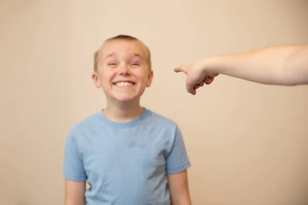 Carefree boy smiles while he is in trouble — 스톡 사진