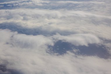 Gökyüzü ve kabarık bulutlar. Uçak penceresinden görüntüle