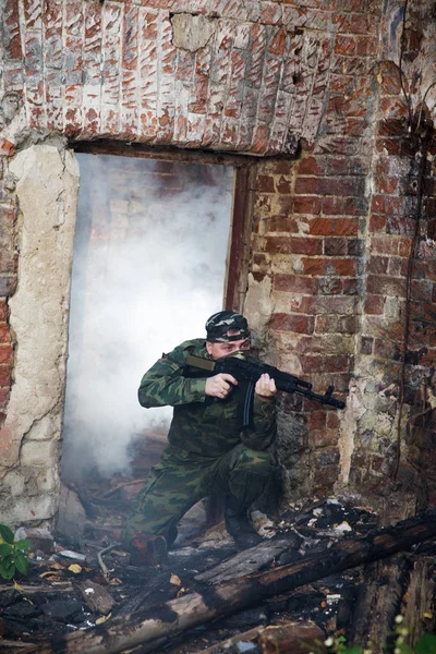 Soldado o miliciano en camuflaje con rifle de asalto AK luchando en ruinas — Foto de Stock
