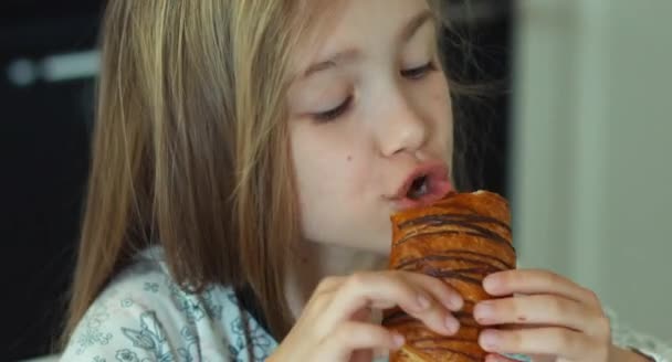 Extreme Nahaufnahme Porträt glückliches Mädchen, das süße Brötchen isst. Daumen hoch. ok — Stockvideo