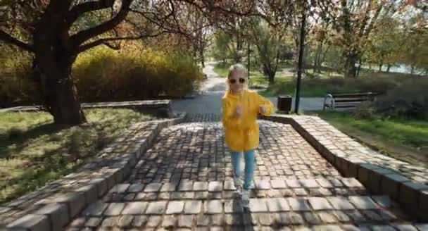 Bambino corre su per le scale nel parco e guardando la fotocamera — Video Stock