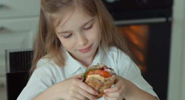 Kind bekijken sandwich onderzocht en glimlachend in de camera. OK. Duim omhoog — Stockvideo
