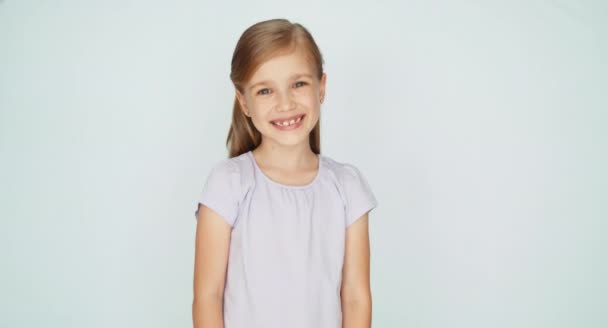 Thumbs up. Ok. Girl laughing at camera. Child is on the white background — Stock Video