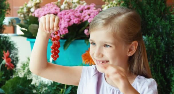 Ragazza che mostra un mucchio di ribes rosso. Ragazza che mangia ribes. Pollice in alto. Va bene. — Video Stock