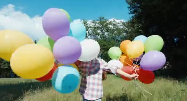 Portrait happy girl spinning with balloons — Stock Video