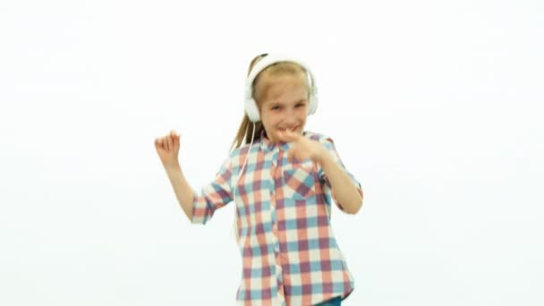 Girl listening music and dancing on the white background — Stock video