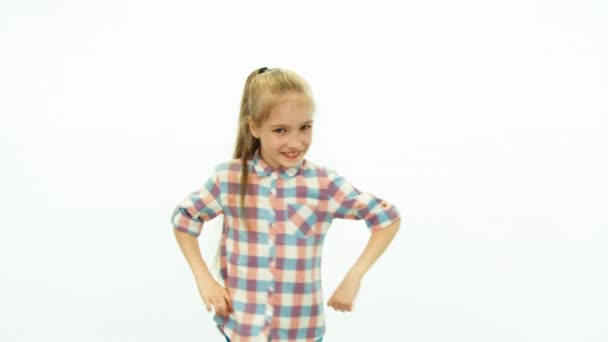 Cute girl dancing on the white background and smiling at camera — Stock Video