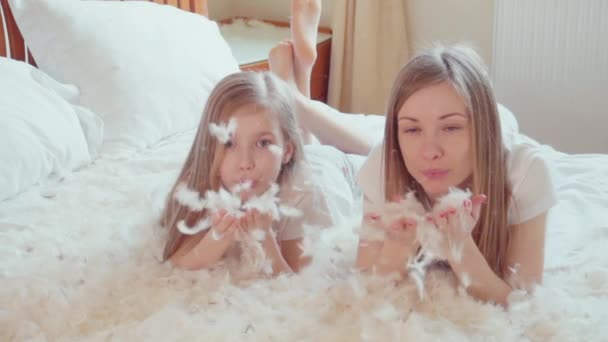 Cute happy girls playing with fluff and feathers. Slowmotion — Stock Video