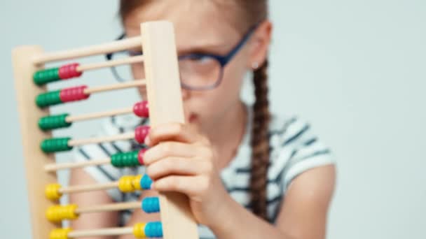 Extreme close up portrait girl 7-8 years old using abacus — Stock Video