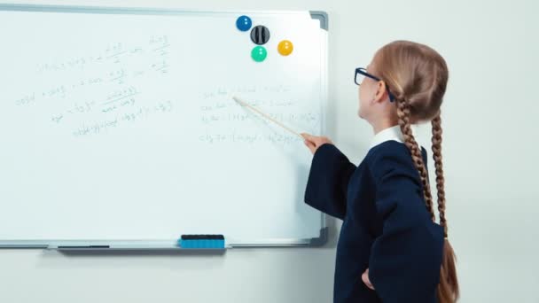 Little student holding pointer standing near whiteboard. Thumb up. Ok — Stock video