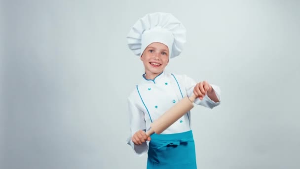 Chef cook child 7-8 years dancing with rolling-pin on white background — Stock Video