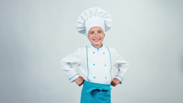 Szakács szakács gyerek 7-8 év rendben mutatja a kamera állandó elszigetelt fehér background — Stock videók