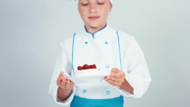 Little chef holds in hands biscuit cake sniffing and gives you — Stock Video