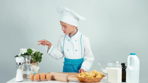 Portrait young baker girl holds rolling pin in the kitchen smiling at camera isolated on white — Stock Video