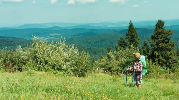 Utazási kislány természetjáró hátizsák, a hegyek a háttérben. Gyermek mosolyogva kamera — Stock videók