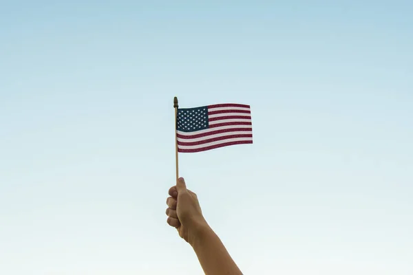 Hand holding American flag