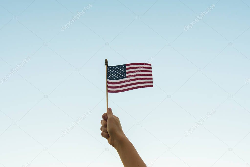 Hand holding American flag