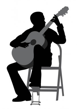 Genç adam akustik gitar çalıyor.