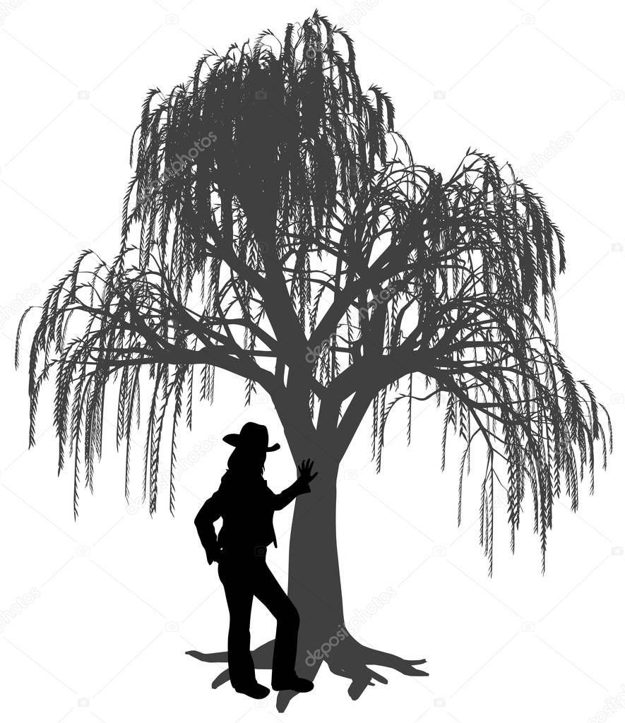 Young woman with hat leaning against a weeping willow tree